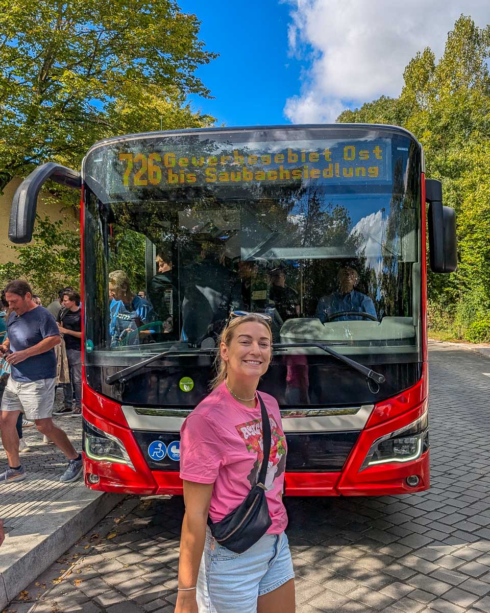 Bailey smiles in front of a bus in Europe
