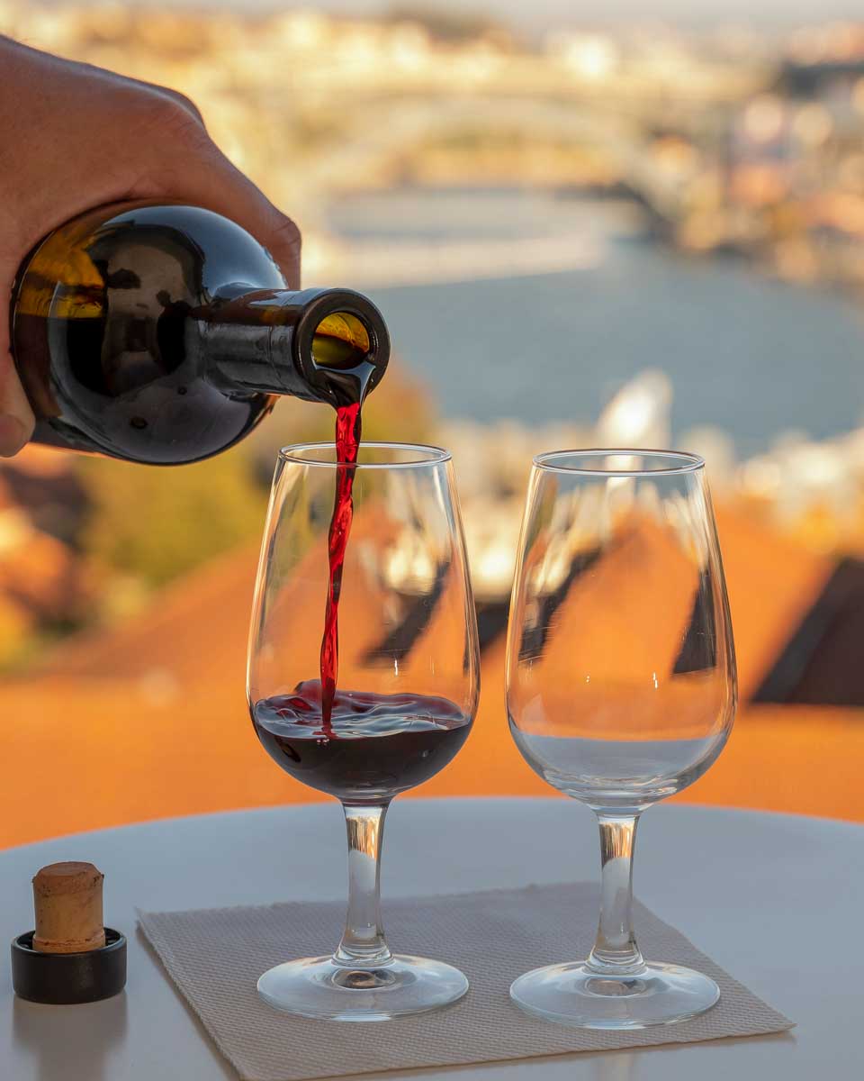 Port-wine-being-poured-at-sunset-in-Vila-Nova-de-Gaia-Porto-Portugal