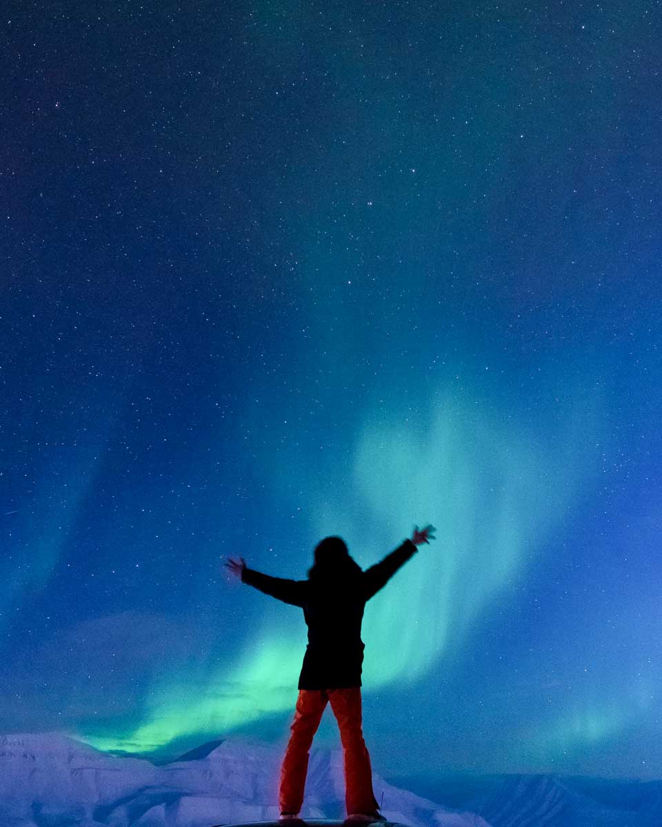 A-person-stands-looking-at-Aurora-Northern-Lights-in Iceland
