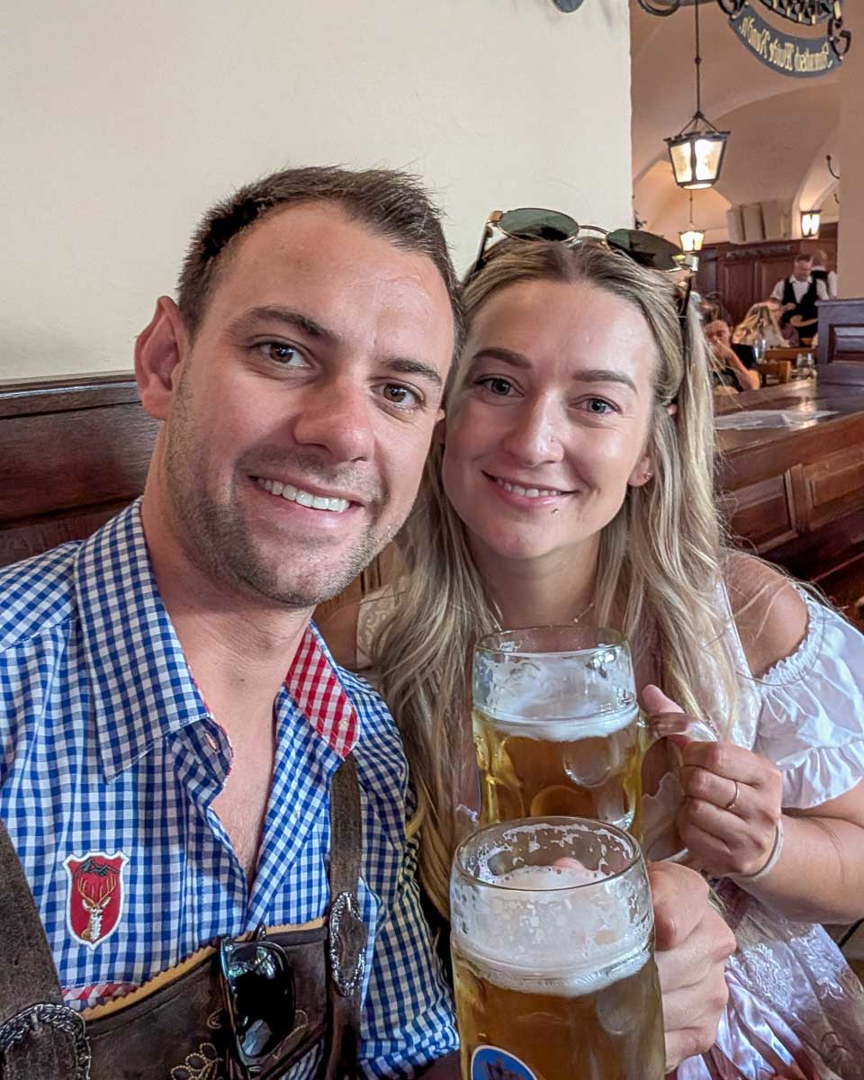 Daniel-and-Bailey-smile-and-drink-beer-in-a-bar-in-Munich-Germany during Oktoberfest