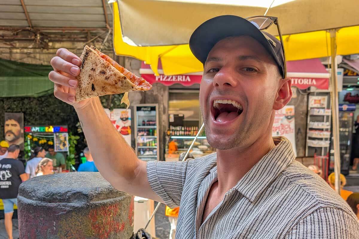 Daniel eats pizza in Naples Italy