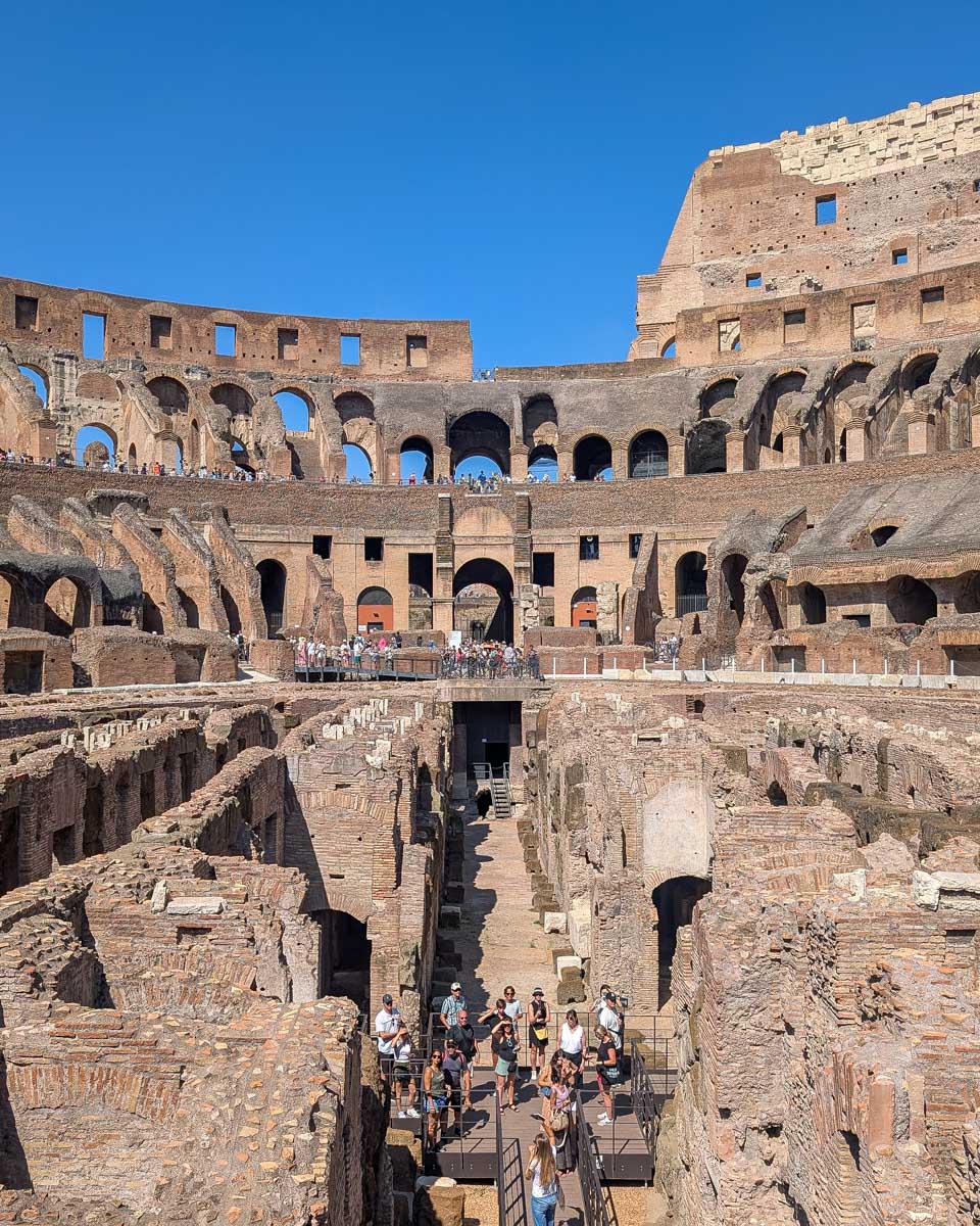 People-down-in-the-arena-of-the-colosseum-in-Rome-Italy-on-a-tour-of-the-Vatican