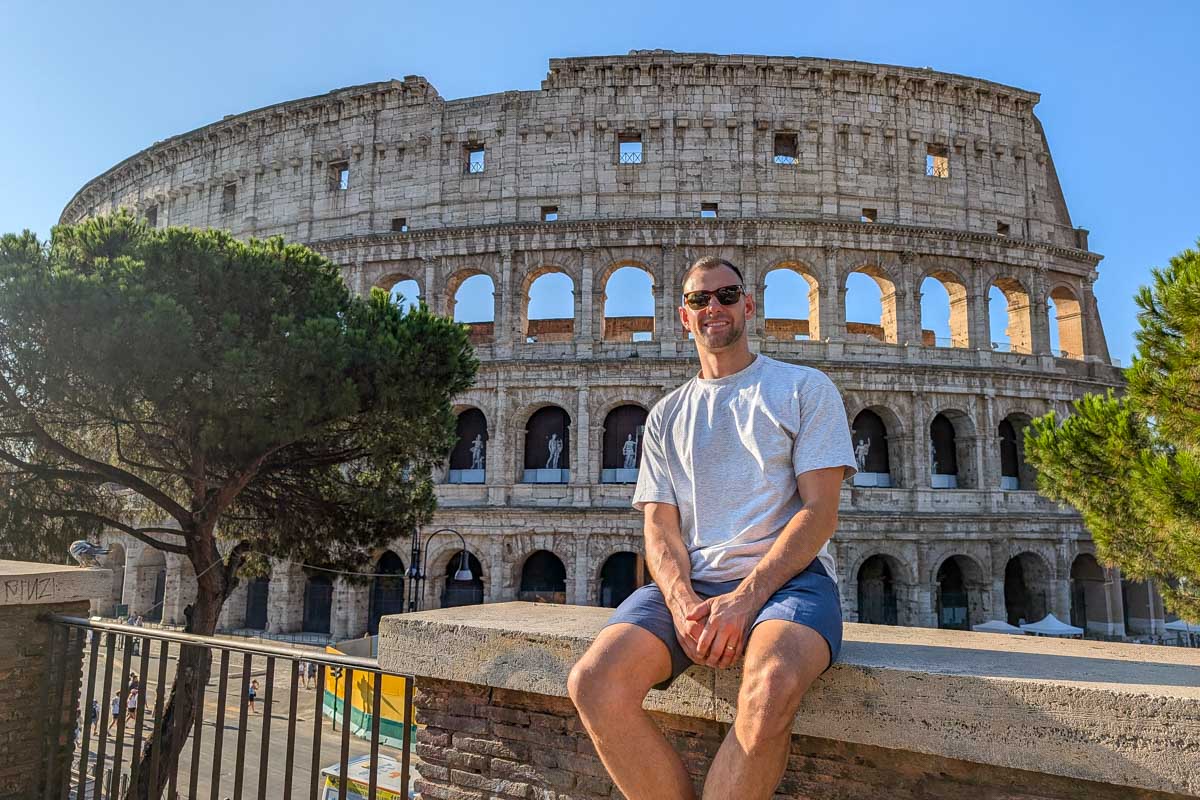 Daniel-sitting-outside-of-the-colosseum-in-Rome-Italy-2