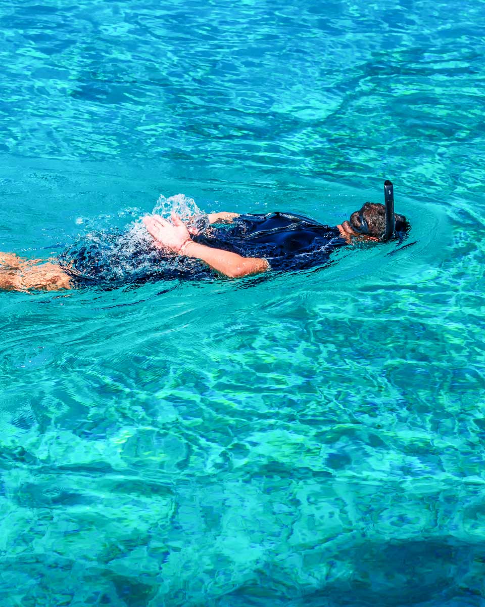 Daniel-snorkels-in-the-water-of-Rhenia Island Greece