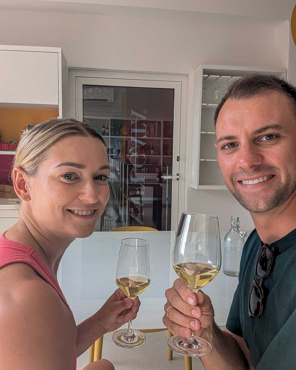 Bailey-and-Daniel-drink-wine-on-a-wine-in the Lavaux region of Switzerland