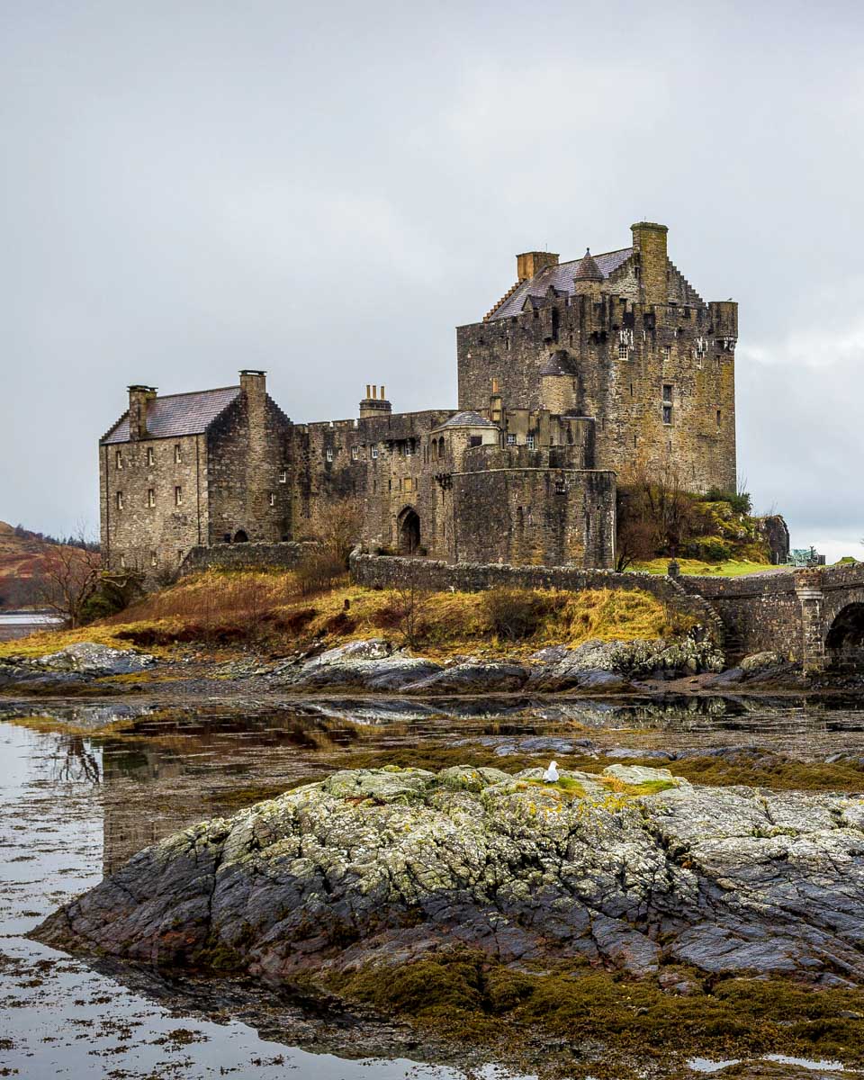 Looking at Eileen Donan castle on a foggy day in the Scottish Highlands Scotland
