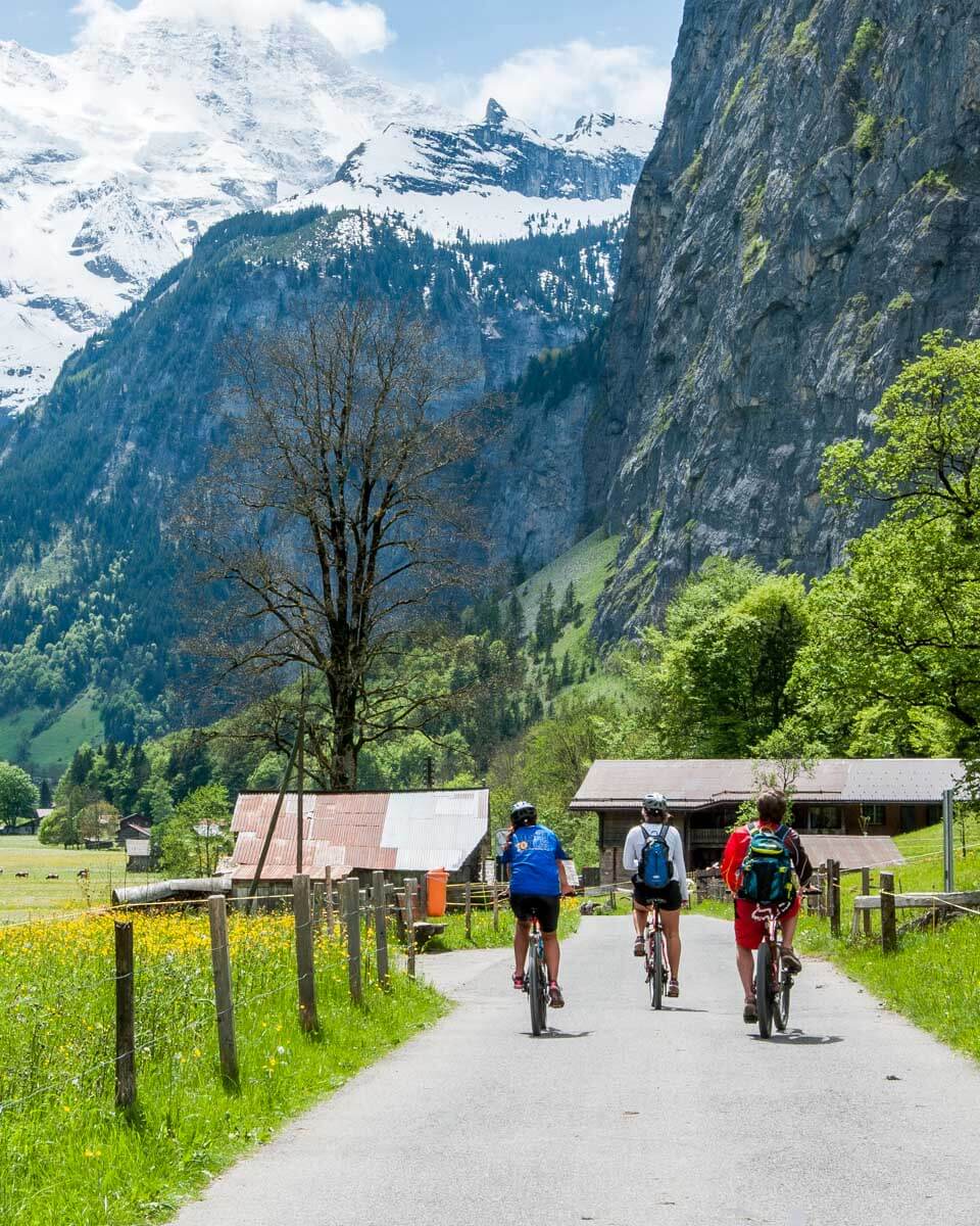 People on bikes in Lauterbrunnen Valley in Switzerland
