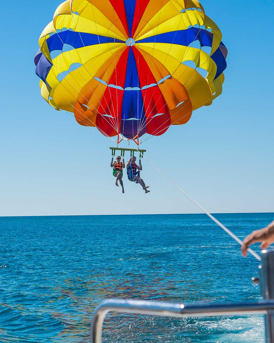 Two-people-parasail-over-the-ocean-near Ibiza Spain