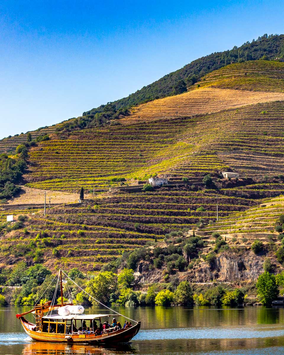 A-boat-travels-down-the-Douro-Valley-River-on-a-tour-from-Porto-Portugal