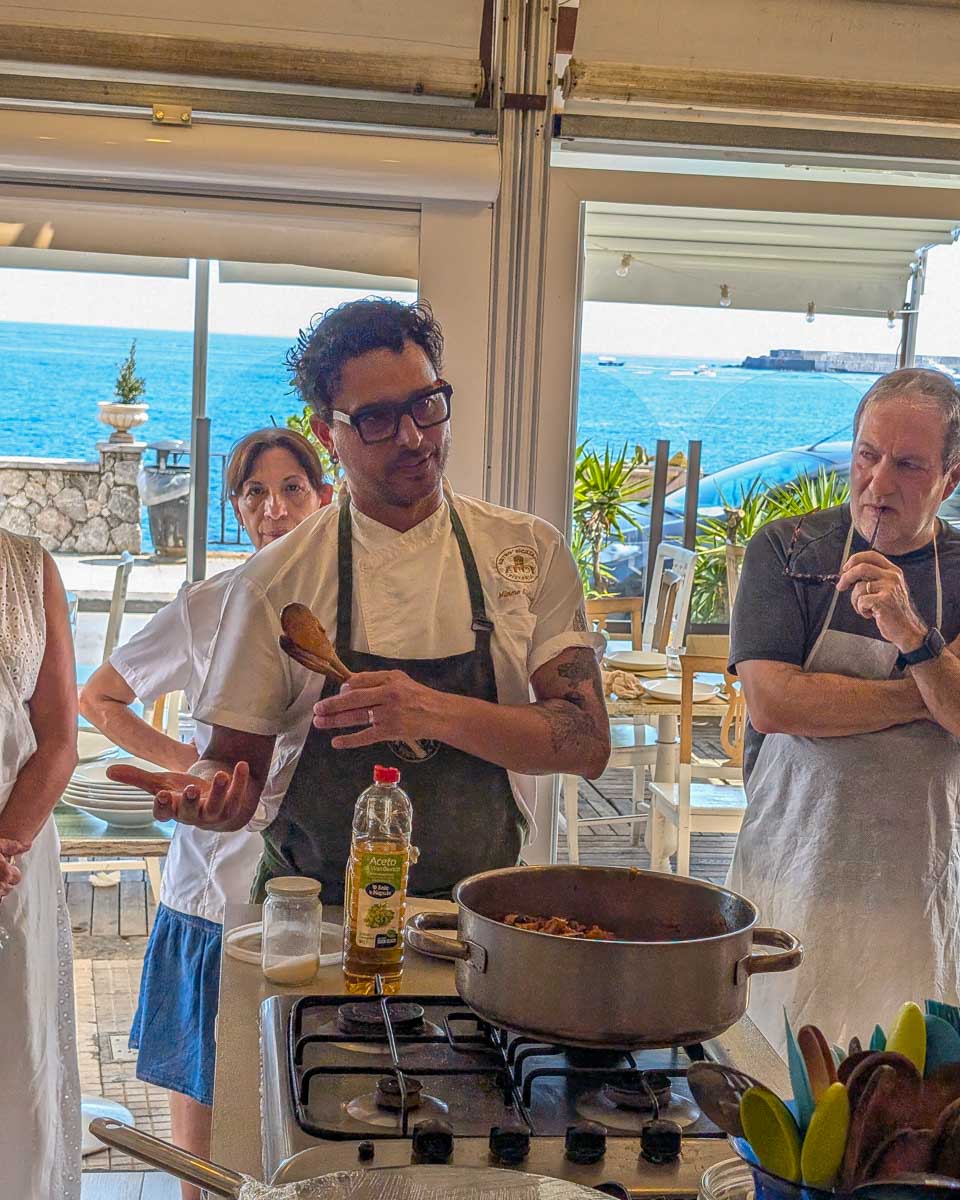 A-chef-speaks-during-a-cooking-class-in-Taormina-Italy