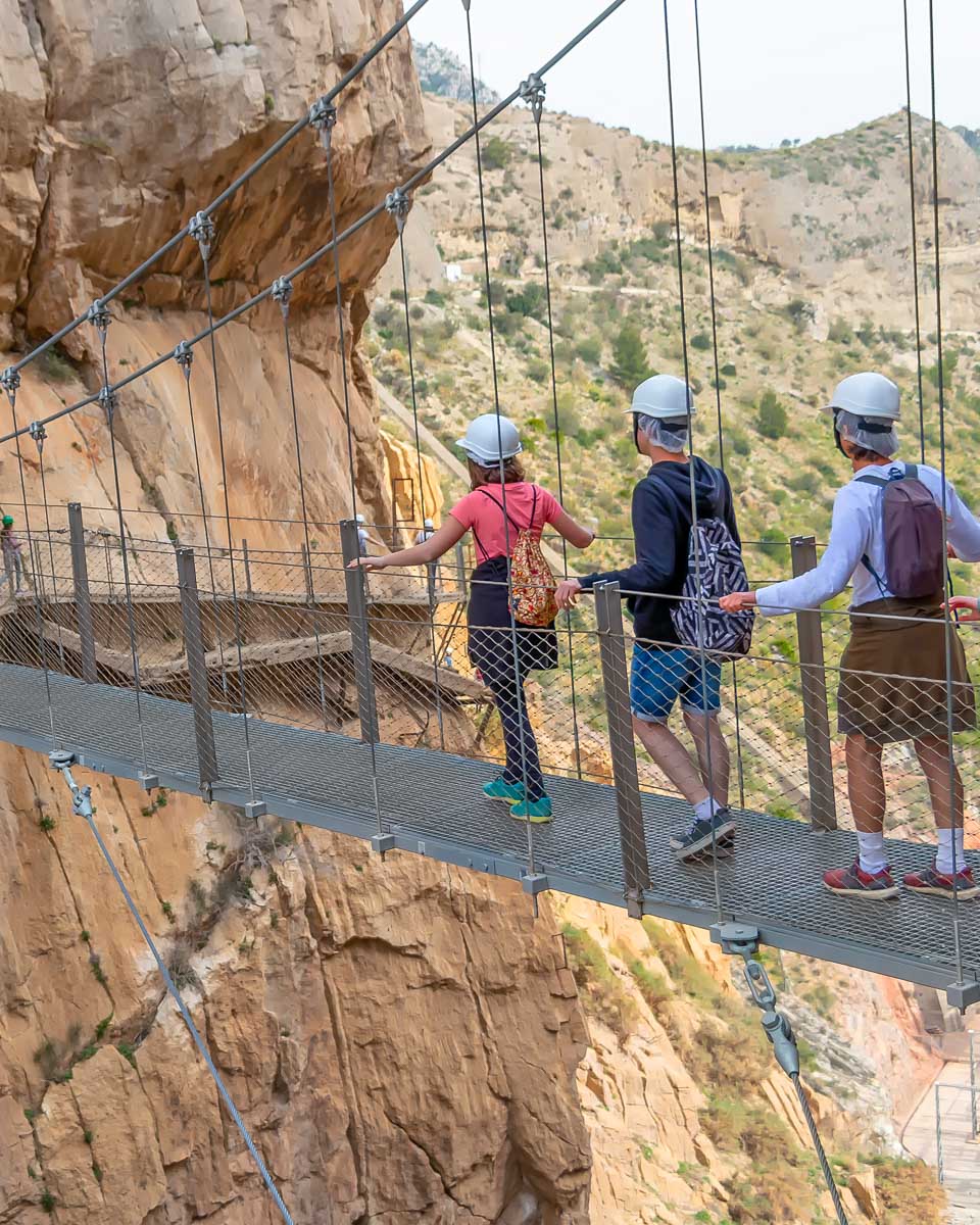 A-group-of-people-walk-across-a-bridge-on-the-Caminito-del-Rey-trail-in-Spain