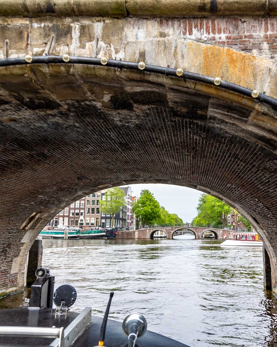 A ship sails under a bridge in Amsterdam, Netherlands 1