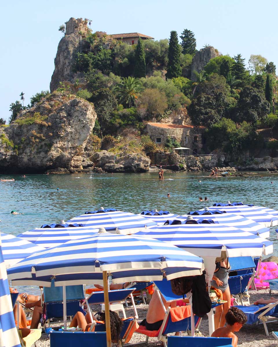Beach chair and umbrellas on the beach at Isola Bella, Taormina, Sicily