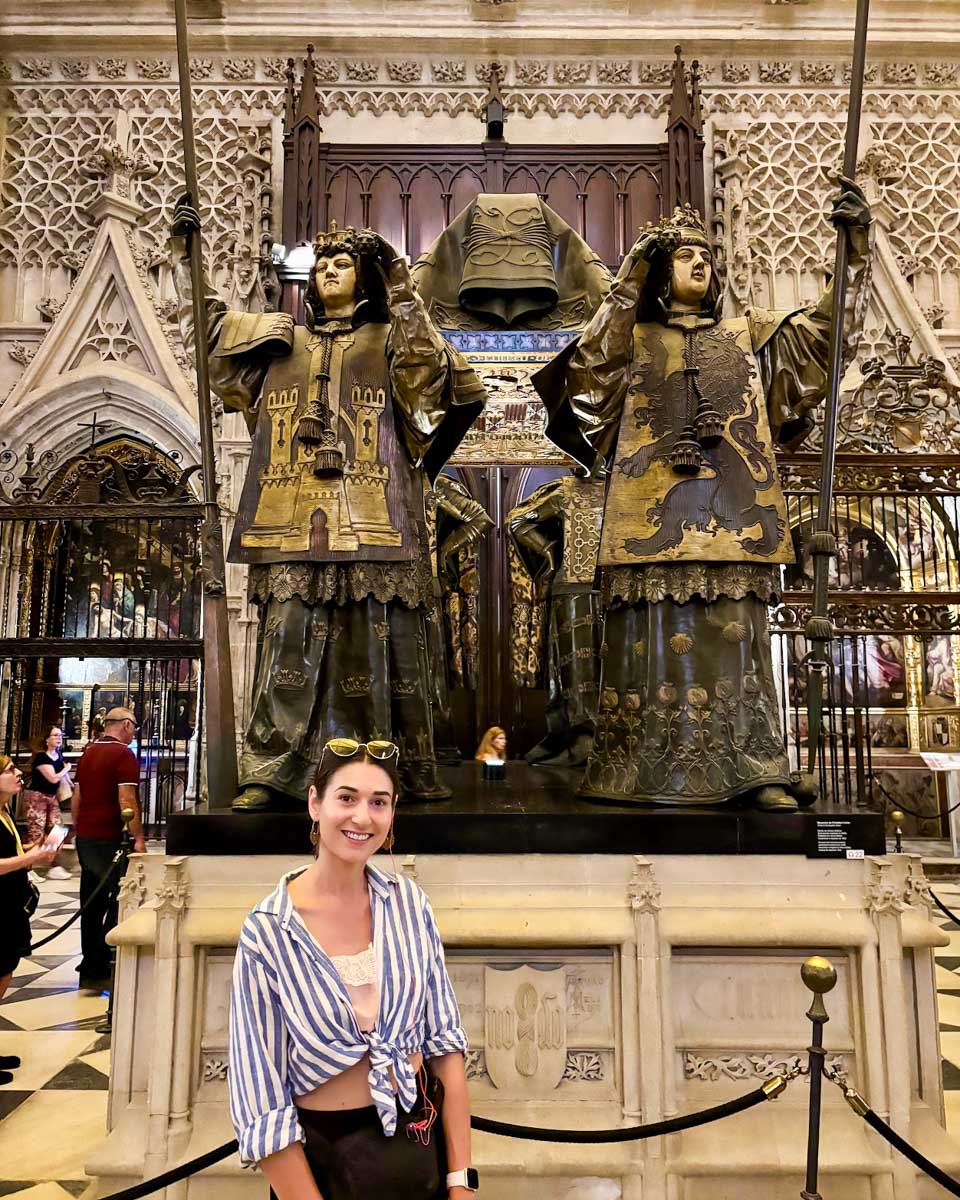 Brittni poses in front of Christopher Colombus' tomb in the Seville Cathedral