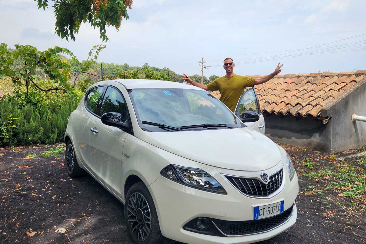 Daniel-with-rental-car-in-Italy on a road trip
