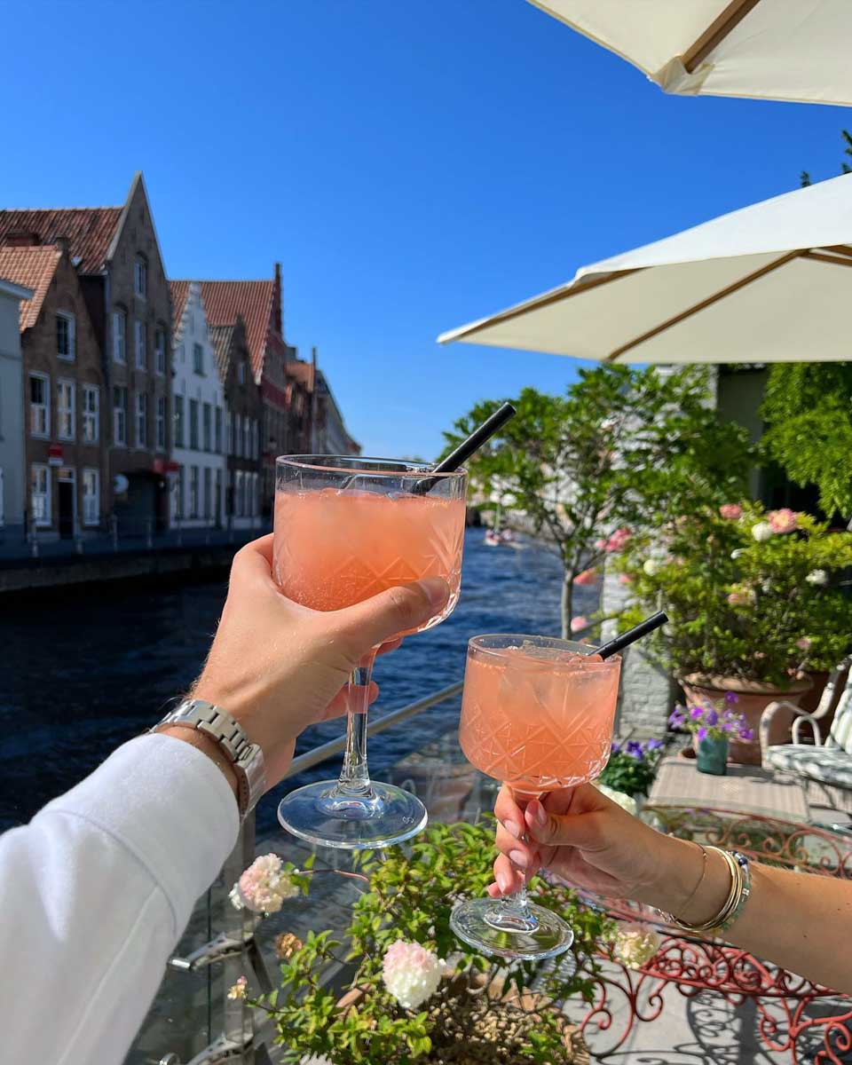People enjoy a cocktail on the outdoor terrace at Hotel Van Cleef