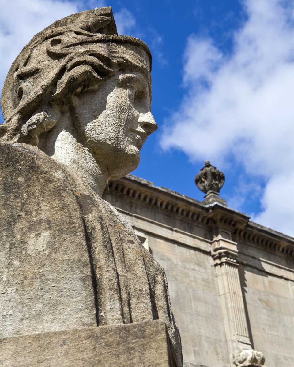 Statues-at-the-Roman-Baths-seen-in Bath England United Kingdom