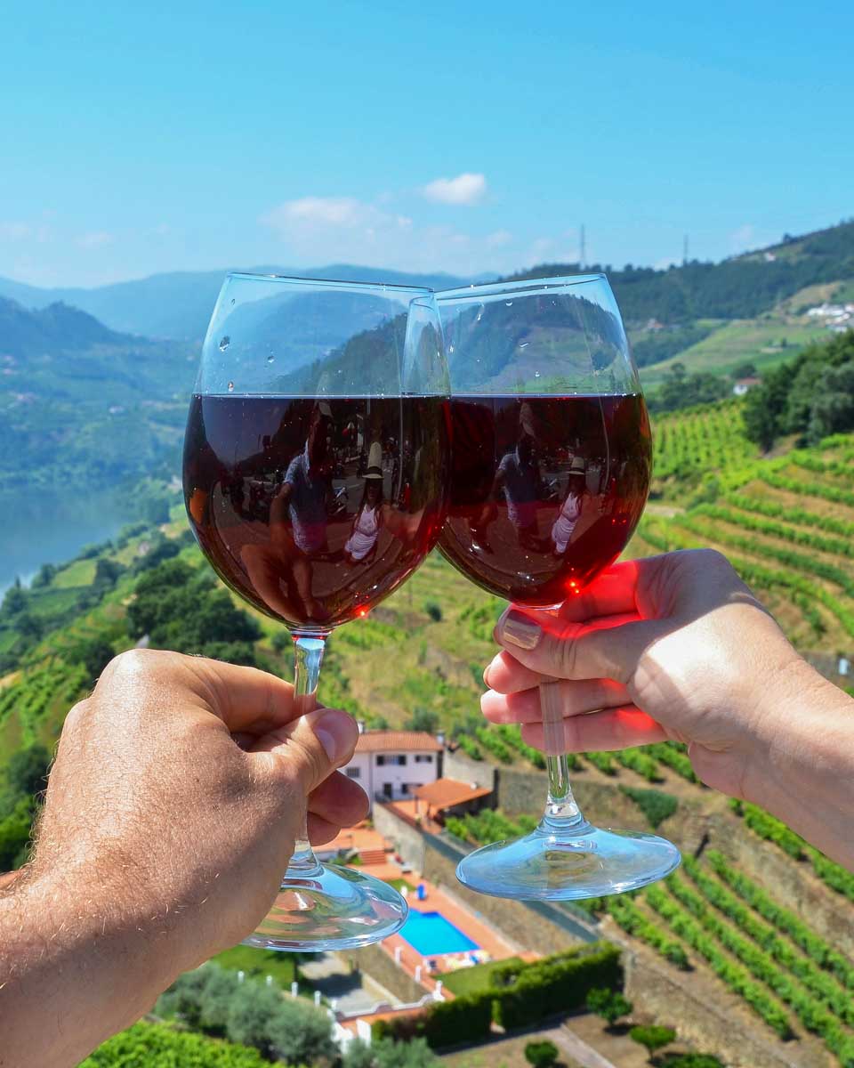 Two-people-drink-wine-in-the-Douro-Valley-on-a-tour-from-Porto-Portugal