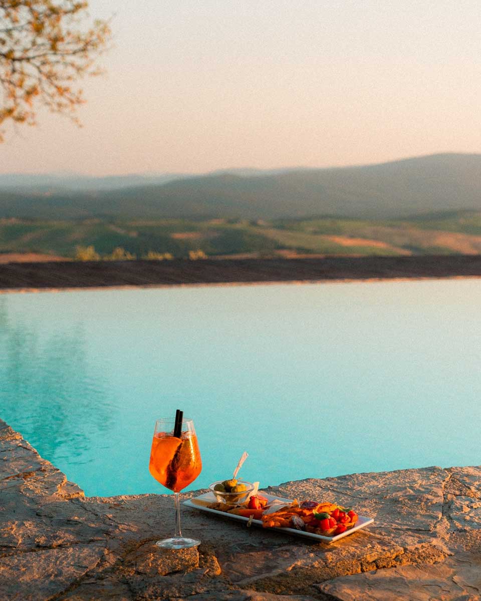 View of a cocktail inf ront of the pool at Castello La Leccia in Tuscany