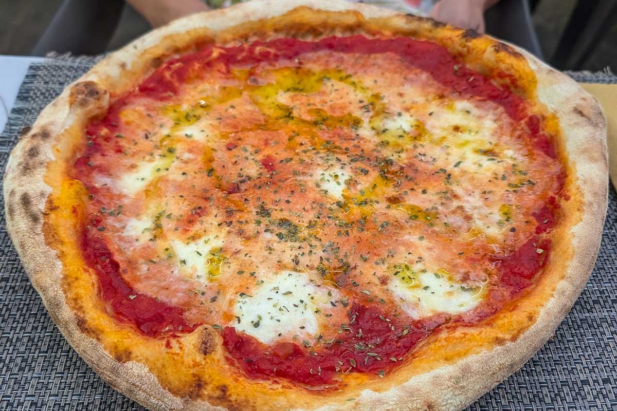 Bailey-eats-pizza-in Cefalu Sicily Italy