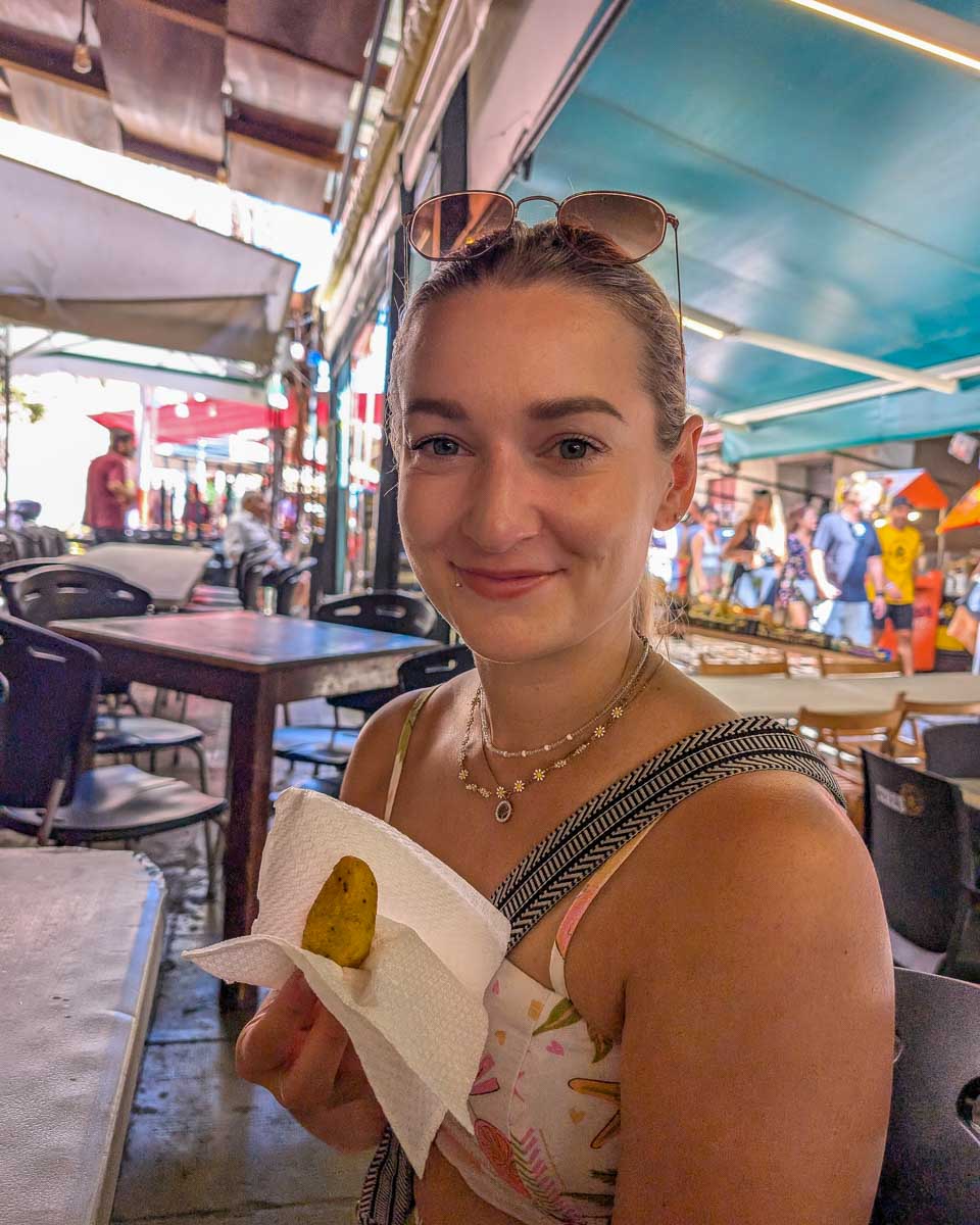 Bailey-holds-food-on-a-food-tour-in-Palermo Sicily-Italy