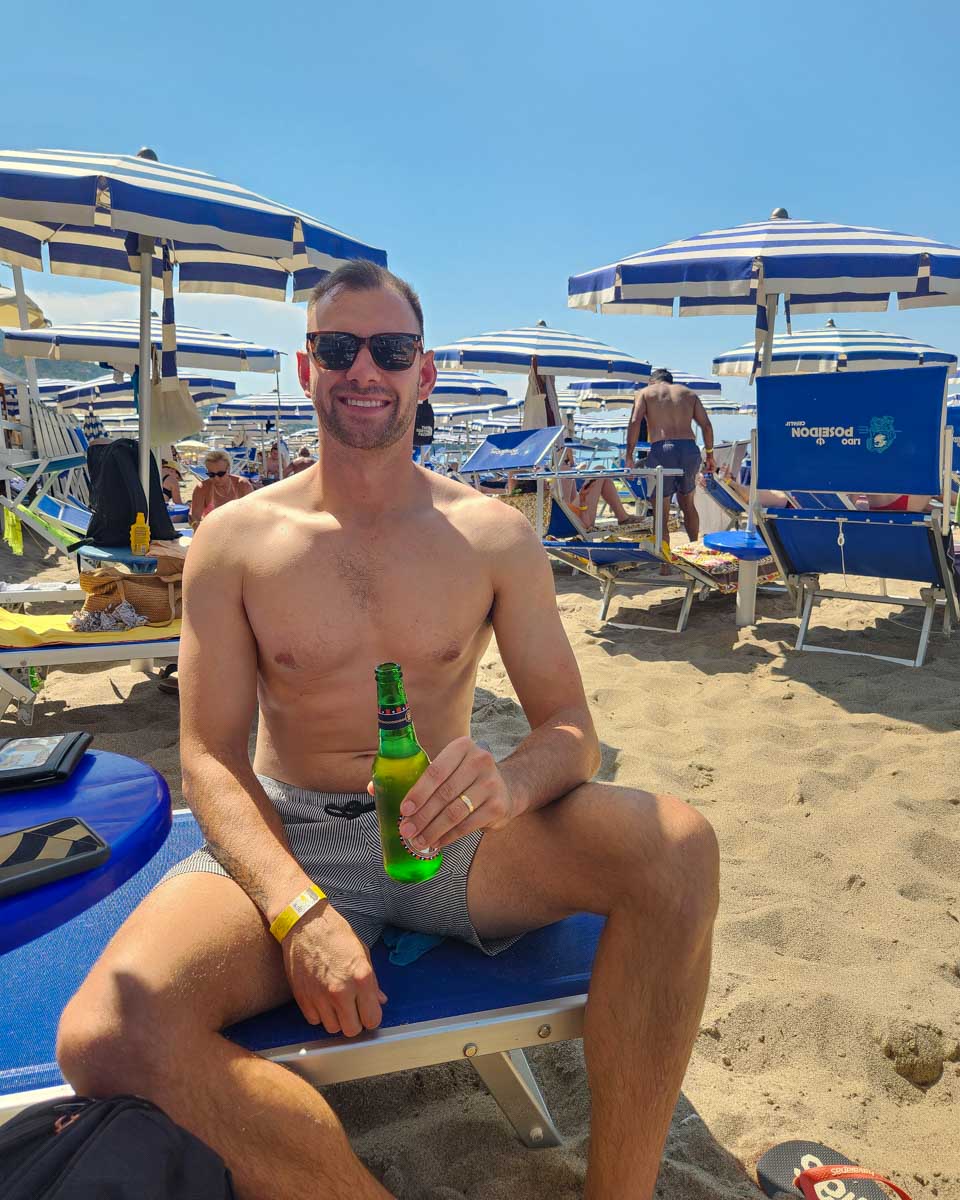 Daniel-at-the-beach-drinking-a-beer-in-Monterosso al Mare in Cinque Terre Italy