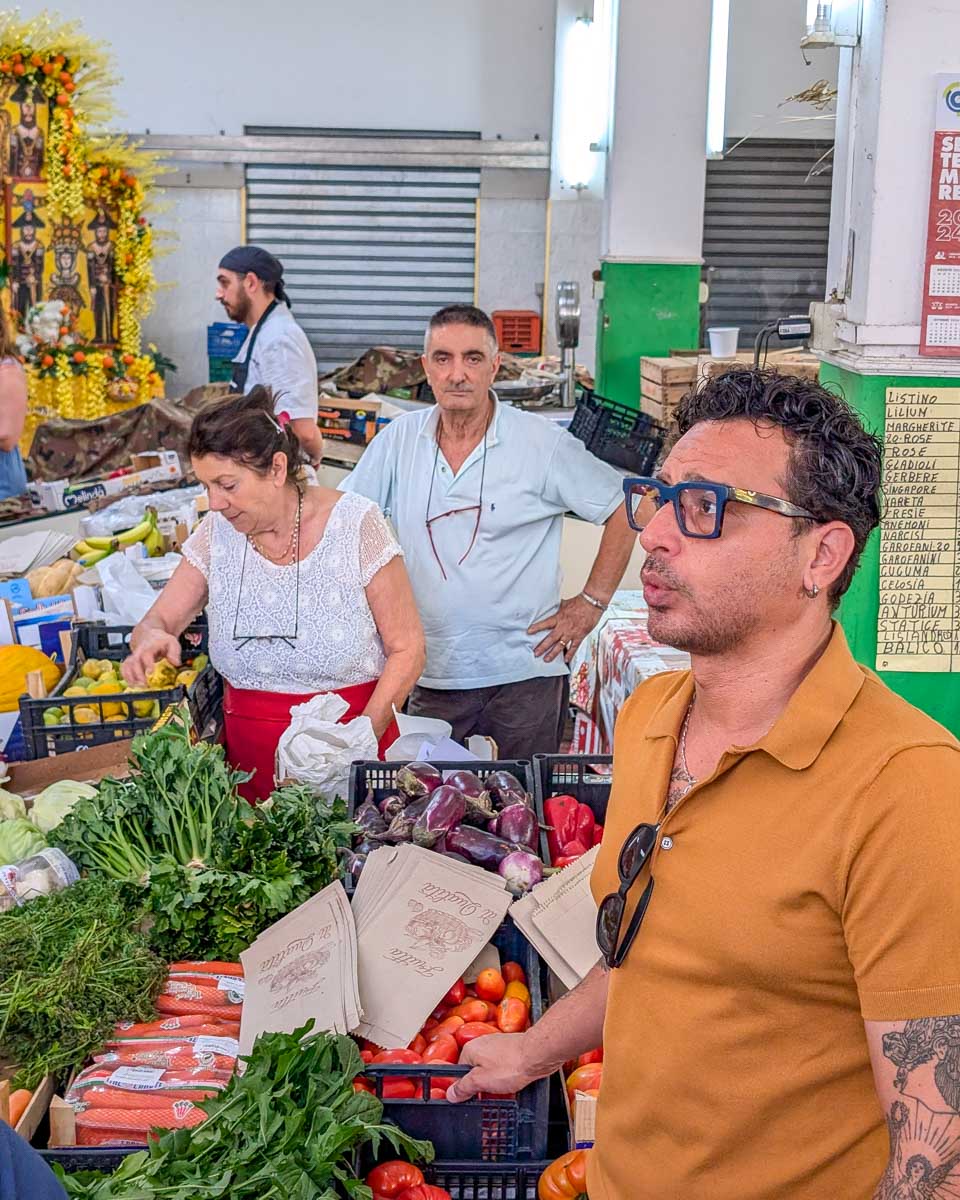People-at-a-market-during-a-cooking-class-in-Taormina-Italy