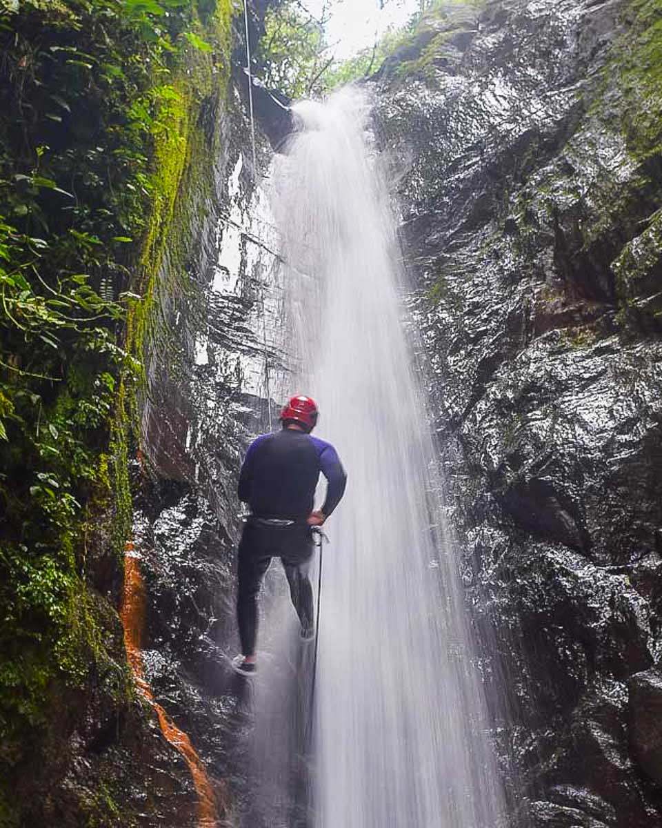 A-person-rappels-down-a-waterfall-canyoning-in-Sao Miguel Portugal