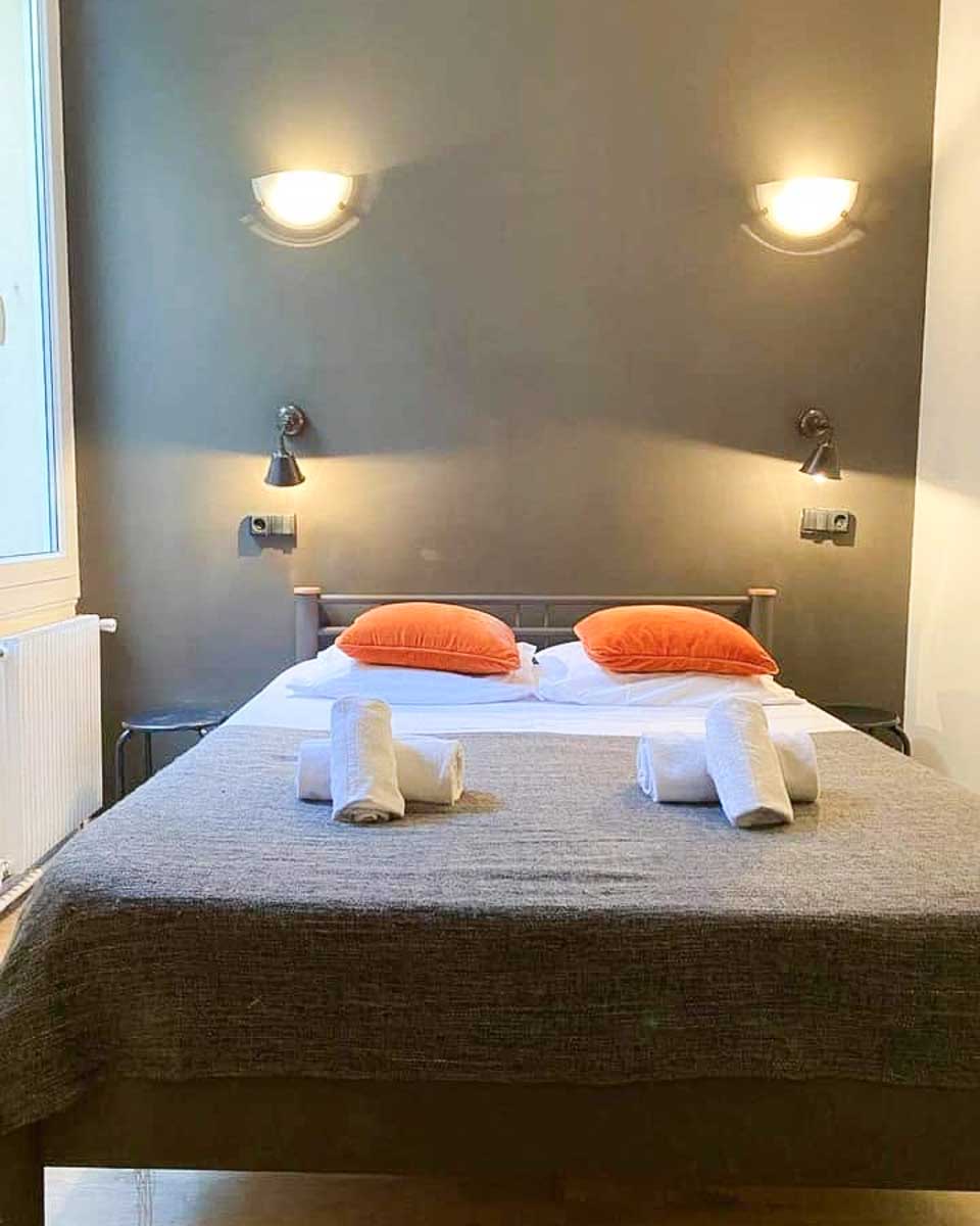 Bed in hotel room at Hotel Chanteclair in Cannes