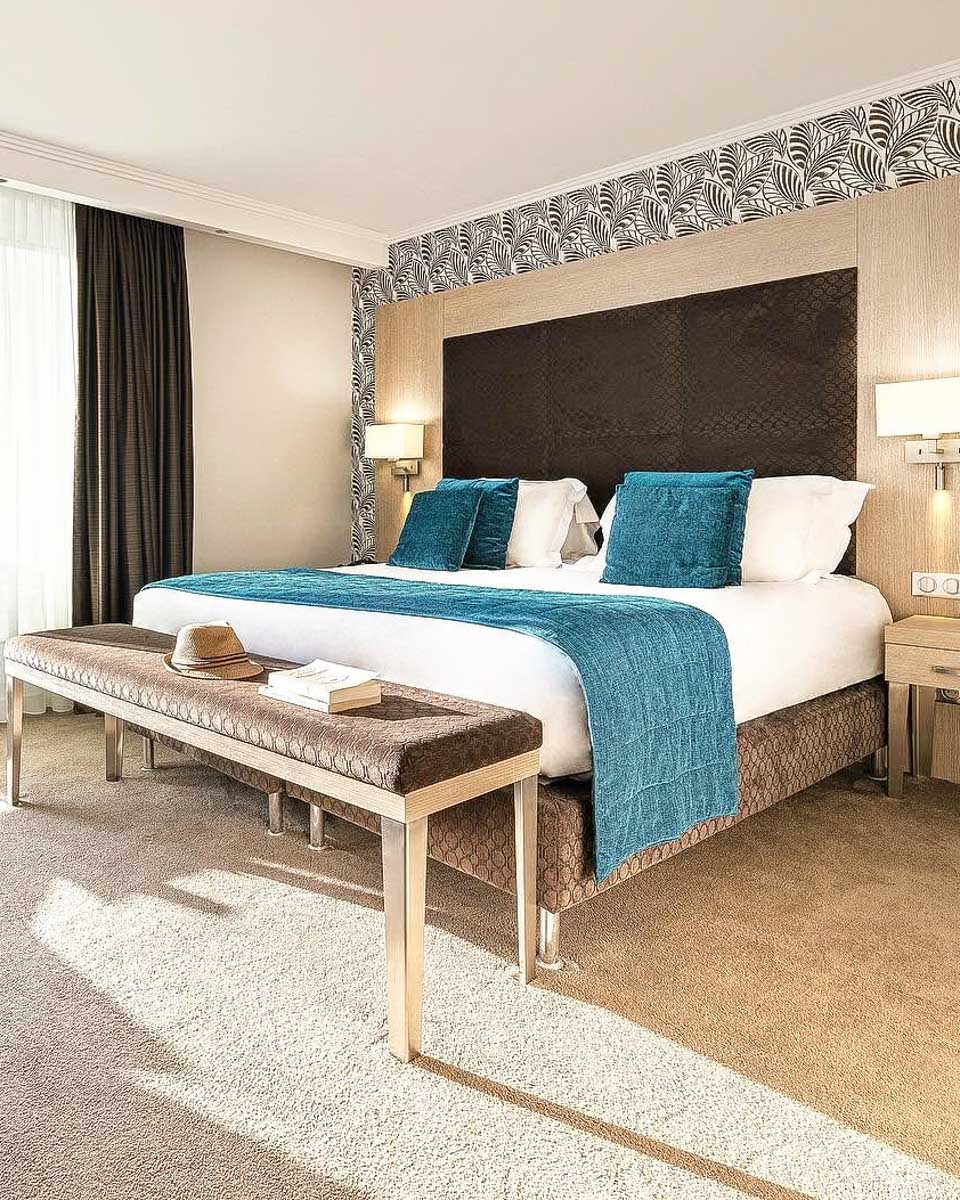 Bed in the hotel room at Juliana Hotel Cannes